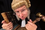 22032231 - grumpy old judge in extreme wide angle closeup with hammer and wig